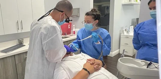 Dentist and team caring for a patient during a general dentistry visit