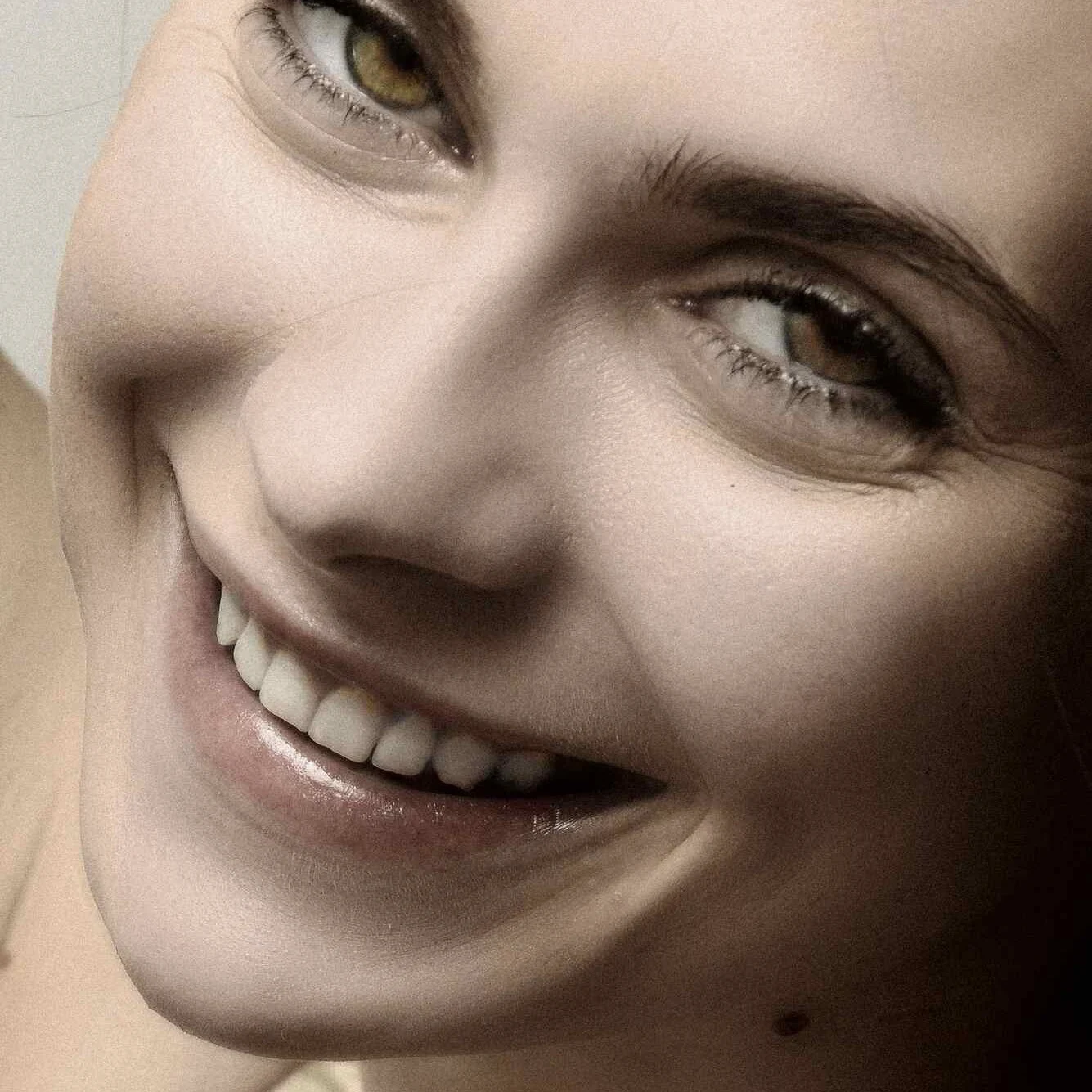 Woman with a bright, natural smile after cosmetic dentistry at Sunshine Smiles Dental Clinic