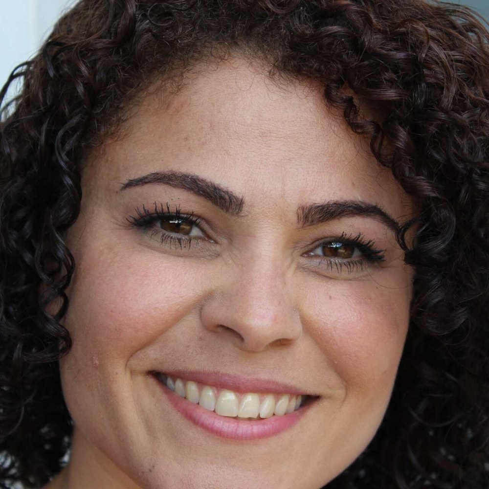 Woman with a bright, natural smile, representing routine dental care at Sunshine Smiles Dental Clinic